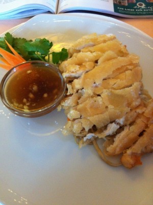 knusprig gebackenes Hühnerfilet mit Knoblauch-Sauce auf vegetarisch gebratenen Nudeln