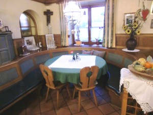 Ambiente - Sitzecke neben Kachelofen im großen Gastraum - Gasthaus Schweinzger - Lang